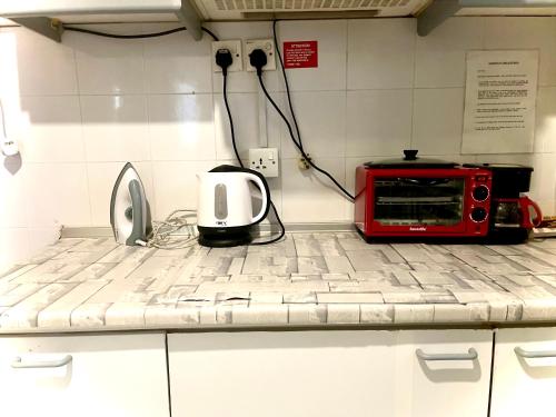 a kitchen counter with a microwave and a toaster oven at Selesa hill homestay in Bentong