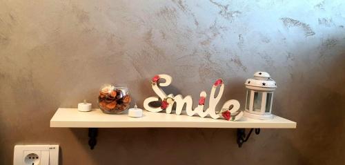 a shelf with a sign that says family on it at Apartman Studio DIAMOND in Subotica