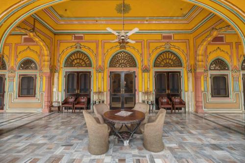 a room with a table and chairs and a ceiling at Hotel Narain Niwas Palace in Jaipur