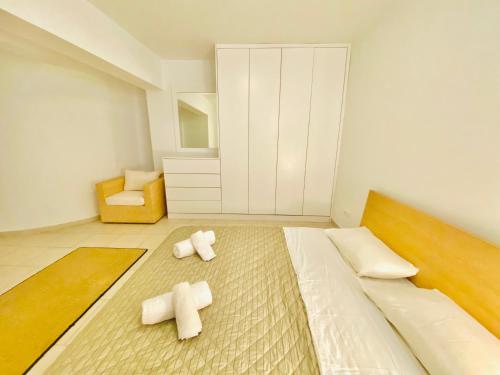 a bedroom with a bed with two crosses on the floor at Elenos Villa in Possidi