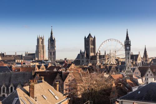 a city skyline with a ferris wheel and buildings at Hotel Gravensteen in Ghent