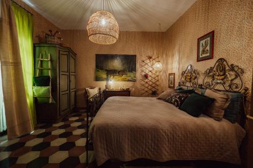 a bedroom with a bed and a chandelier at Locanda del Daino in Lemmi