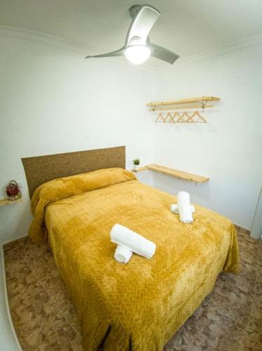 a bedroom with a large bed with two towels on it at La Tienda de Miguel in El Chorro