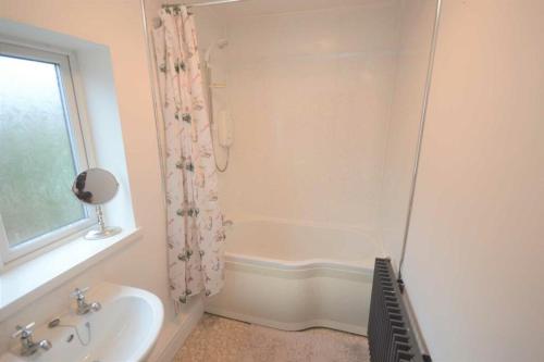 a bathroom with a sink and a shower at Lovely 3 bedroom house in Romiley, Stockport with parking for 3 cars in Romiley
