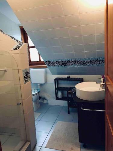 a bathroom with a sink and a toilet at Kis Pele nyaraló in Balatongyörök