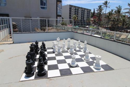 a chess board on a balcony with a chess set at Seagull 101 in Margate