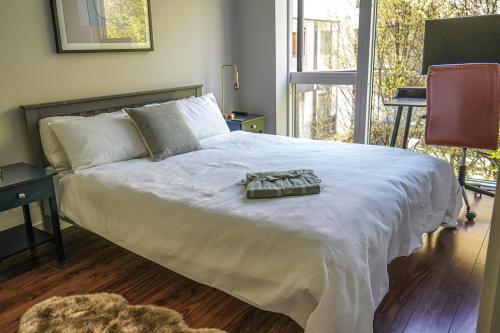 a bedroom with a large white bed and a window at Charming Duplex in Grand Canal in Dublin