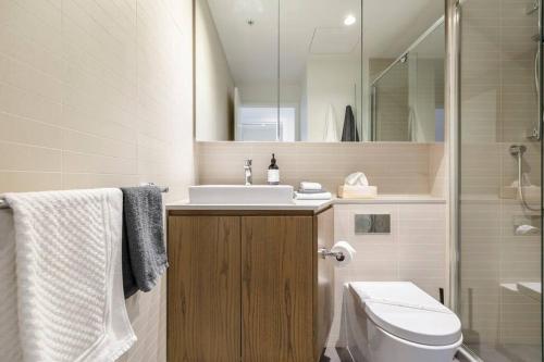 a bathroom with a sink and a toilet and a shower at Peaceful 2 bedroom unit with Free parking in Melbourne