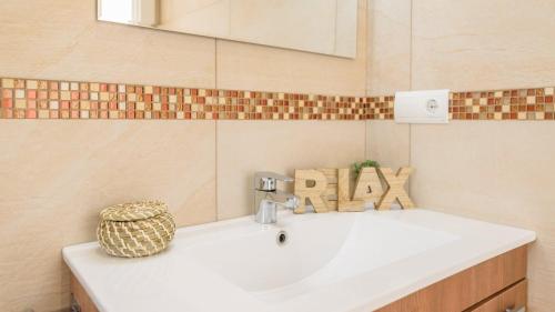 a bathroom with a white sink and a mirror at Casa El Refugio de Árchez by Ruralidays in Árchez