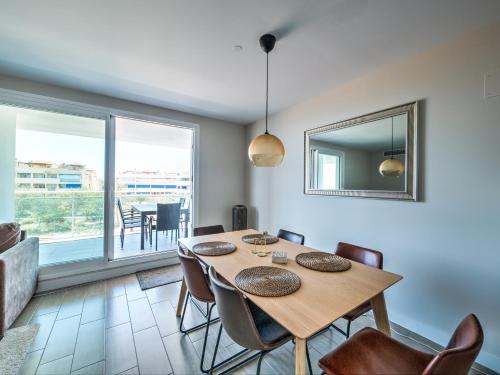 a dining room with a table and chairs at New beach front apartment with large balcony in Torrox Costa