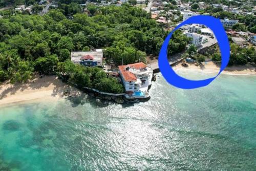 an aerial view of a house on a beach at Relax in front of beach! 3 bd condo with rooftop! in Río San Juan