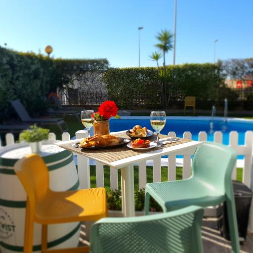 a table with a plate of food and wine glasses at Ibis Jerez De La Frontera Cadiz in Jerez de la Frontera