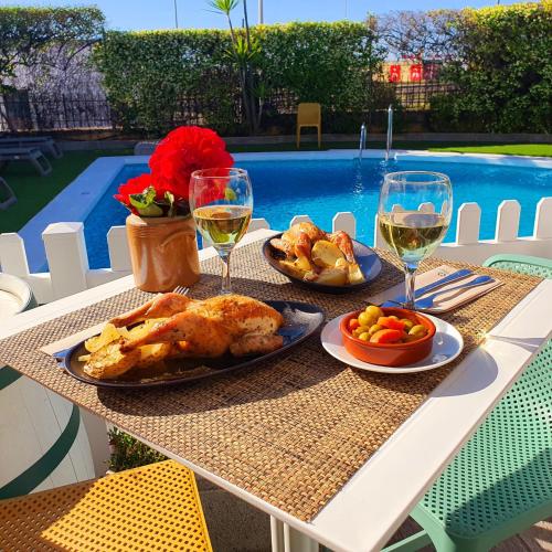 a table with two plates of food and glasses of wine at Ibis Jerez De La Frontera Cadiz in Jerez de la Frontera