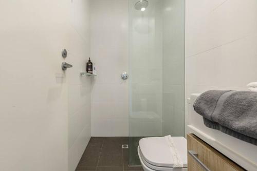 a bathroom with a toilet and a glass shower at Walk to the Grand Prix Track 01583 in Melbourne