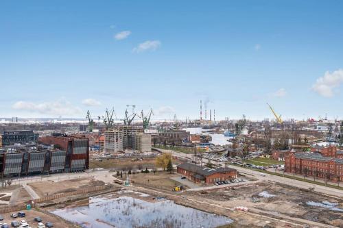 an aerial view of a city with buildings and cranes at Viewpoint - Bastion Wałowa by Grand Apartments in Gdańsk