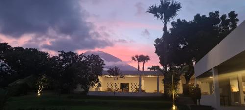a view of a house with a mountain in the background at Palm Springs Bali Dive Resort in Tulamben