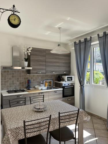 a kitchen with a table and some chairs and a table and a kitchen at Cà del Fili in Lenno