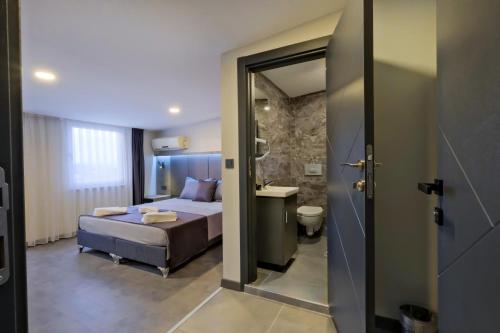 a hotel room with a bed and a bathroom at The Queen Hotel in Istanbul