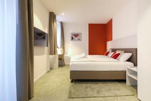 a hotel room with a bed and a television at Boutique Hotel Piazza Grande in Locarno