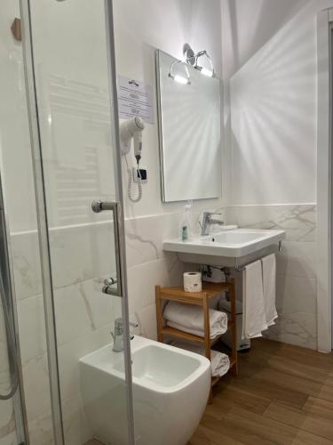 a white bathroom with a sink and a shower at Residenza Madonna in Pompei