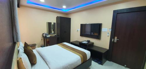 a hotel room with a bed and a television at Annapurna Hotel in Bīrganj