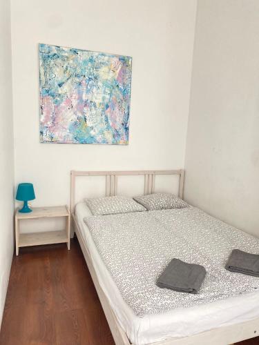 a bedroom with a bed and a painting on the wall at Platan 17 in Świnoujście