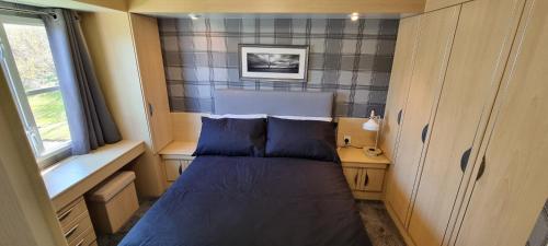 a bedroom with a bed in a small room at The Glen View in Port Seton