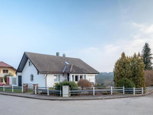 a white house with a fence in front of it at Haus Pia in Pfalzgrafenweiler