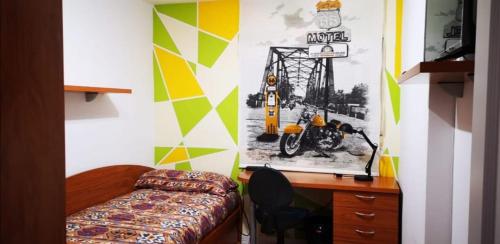 a bedroom with a desk and a motorcycle on the wall at HABITACION INDIVIDUAL in Valencia