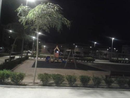 a park at night with a playground and a swing at Modern apartment 250m from the sea with parking space behind gate in Pilar de la Horadada