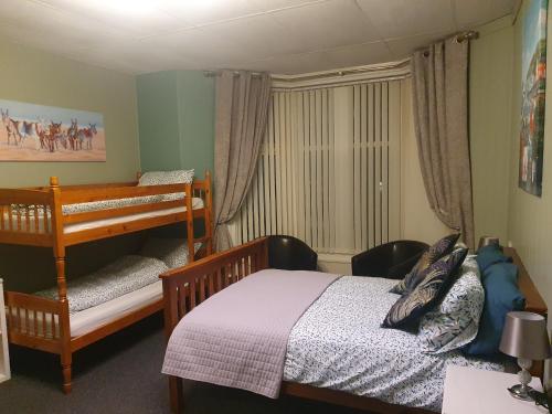a bedroom with a bunk bed and a crib at Maydene Hotel in Blackpool
