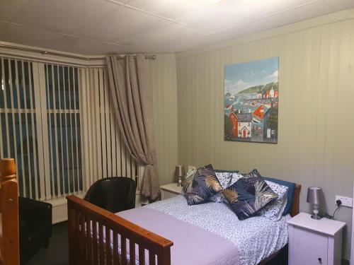 a bedroom with a bed and a painting on the wall at Maydene Hotel in Blackpool