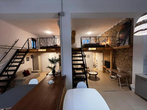 a living room with a loft with a staircase at Soho Boho Apartments - with sunny rooftop terrace and fiber optic internet in Alicante