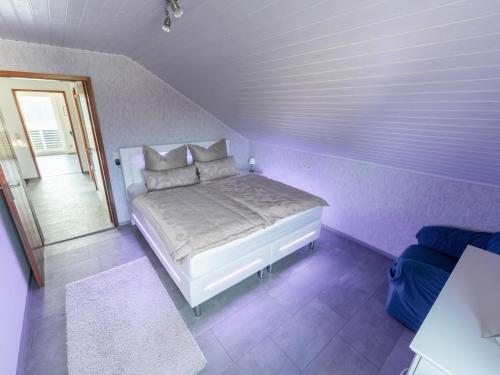 a bedroom with a bed in a purple room at Haus Pia in Pfalzgrafenweiler