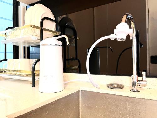 a kitchen sink with a faucet on a counter at Golden House-Atlantis Residence in Malacca