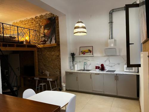 a kitchen with a sink and a table at Soho Boho Apartments - with sunny rooftop terrace and fiber optic internet in Alicante