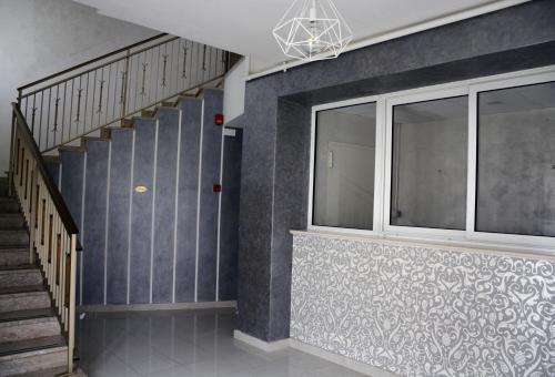 a hallway with a staircase and a window at Hotel Aquila in Scoppito