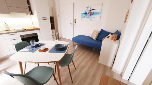 a small kitchen with a table and chairs in a room at NUMANA SEA APARTMENT in Numana