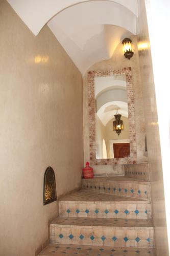 a staircase in a house with a mirror at Riad Asrari in Marrakech