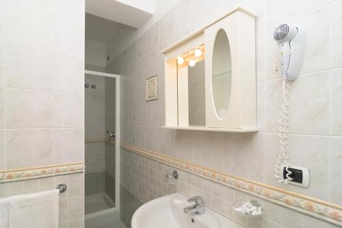 a bathroom with a sink and a mirror at Hotel Villa Fumerie in Ischia