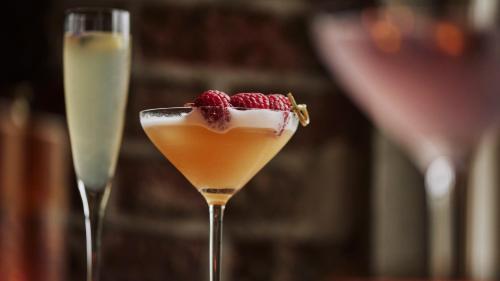 two glasses of drinks with a raspberry on top at The Newbridge on Usk in Usk
