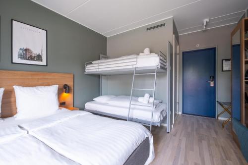 two beds in a room with two bunk beds at Go Hotel Østerport in Copenhagen