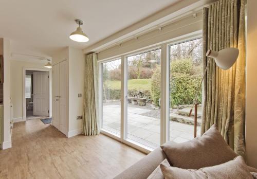 a living room with a large sliding glass door at Skerrow in New Galloway