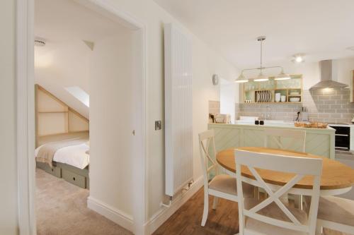 a kitchen and a bedroom with a table and a bed at Skerrow in New Galloway