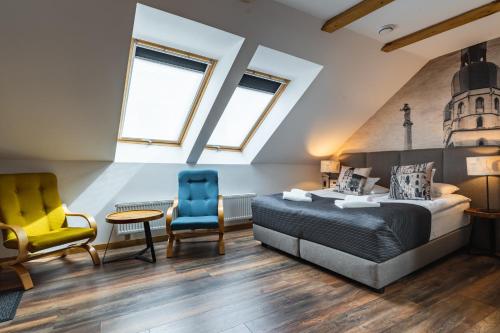 a bedroom with a bed and two chairs at Boutique Slovakia Residence in Košice