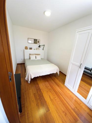 a bedroom with a bed and an open door at Charming Pedra in Braga