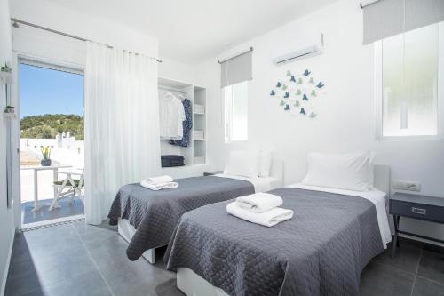a bedroom with two beds with towels on them at VillaPhysis with Private Pool in Lartos