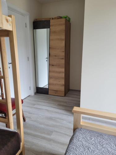a room with a door leading to a bedroom at Aronia Kazbegi in Stepantsminda