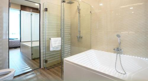 a bathroom with a shower with a tub and a toilet at Execlusive Suite 209 by Forest Khaoyai in Ban Huai Sok Noi