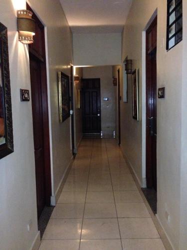 a hallway of a house with a tile floor at Hotel Discovery in Santo Domingo